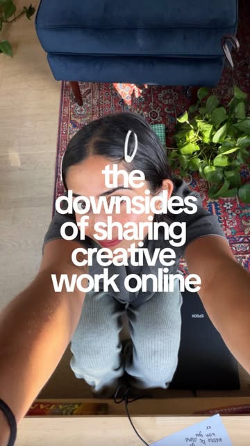 Sabina at her desk, sharing creative work online