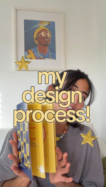 Sabina holding Family Recipes with my design process text and yellow stars